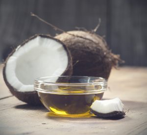 Coconuts and organic coconut oil in a glass jar